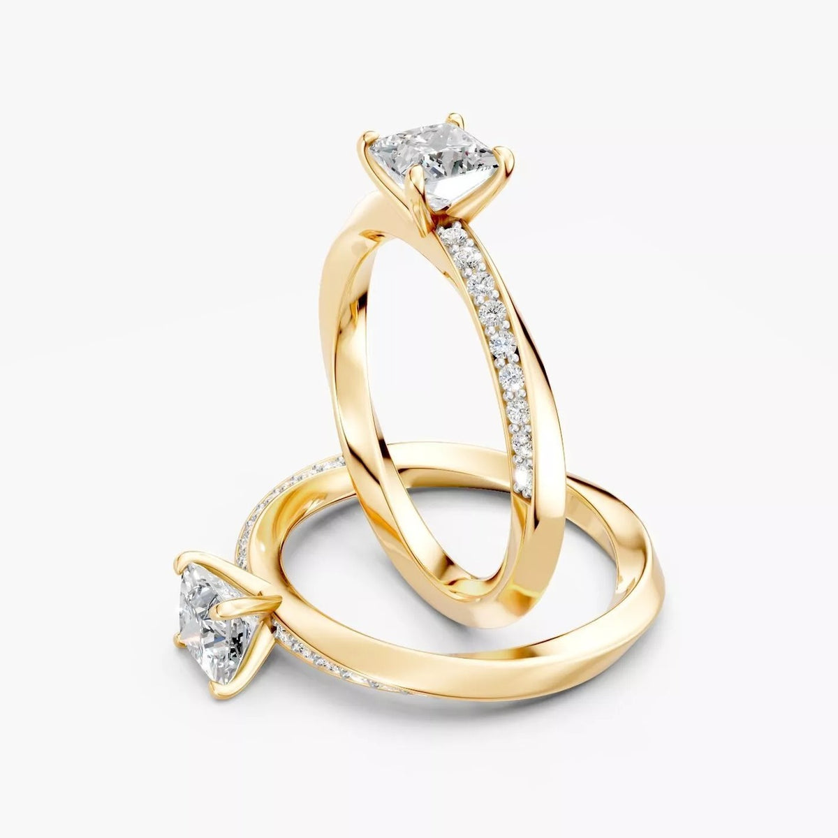 To ZRGM057 diamantringe med snoet pavé-skinne i gulguld